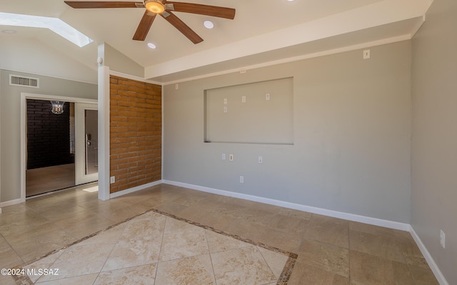 unfurnished room with ceiling fan and vaulted ceiling with skylight