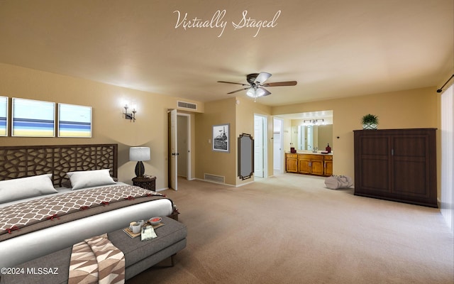 carpeted bedroom featuring ensuite bath and ceiling fan