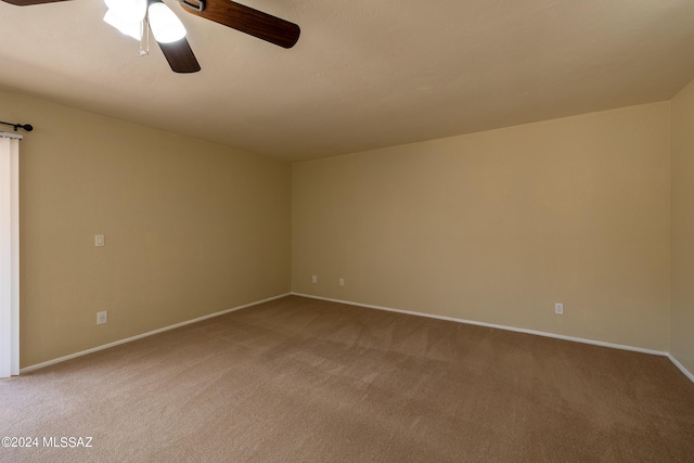 unfurnished room featuring light carpet and ceiling fan