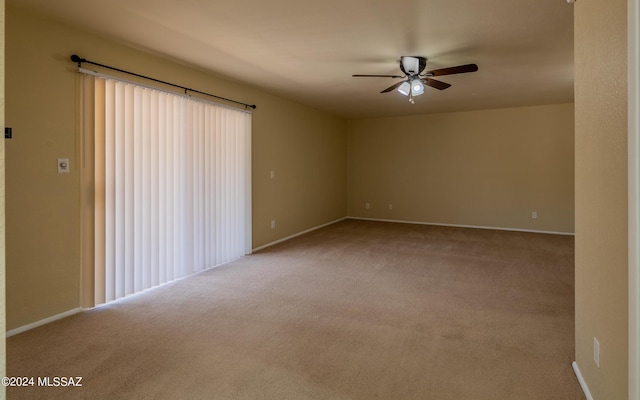 empty room featuring light carpet and ceiling fan