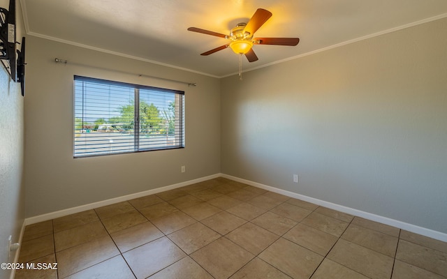 tiled spare room with ceiling fan and ornamental molding