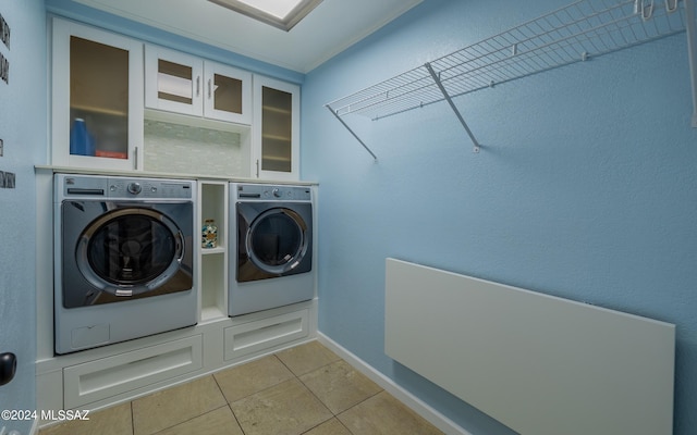 clothes washing area featuring independent washer and dryer and light tile patterned flooring