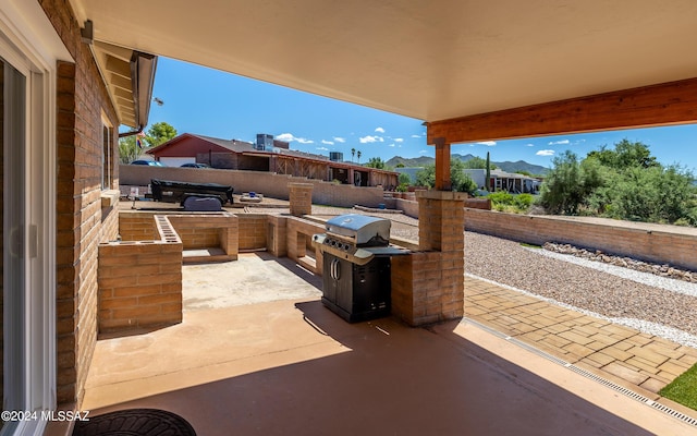 view of patio featuring a grill