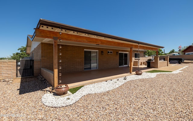 back of house with a patio area and exterior kitchen