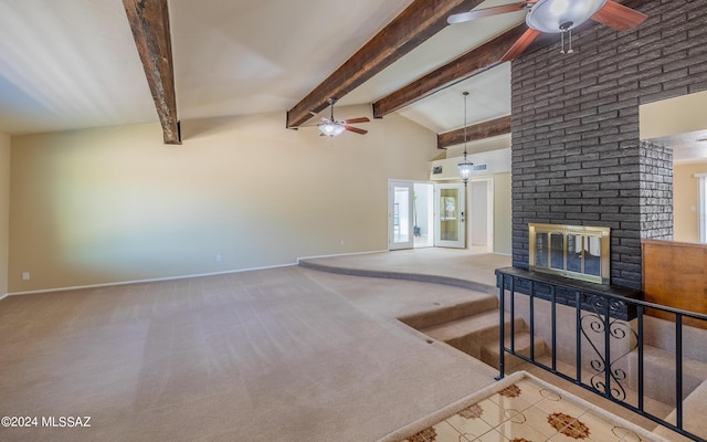 carpeted living room featuring vaulted ceiling with beams, a fireplace, and french doors