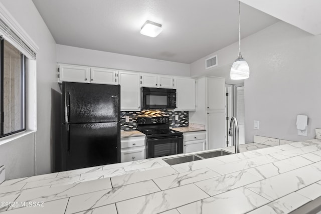 kitchen with pendant lighting, black appliances, white cabinetry, tasteful backsplash, and sink