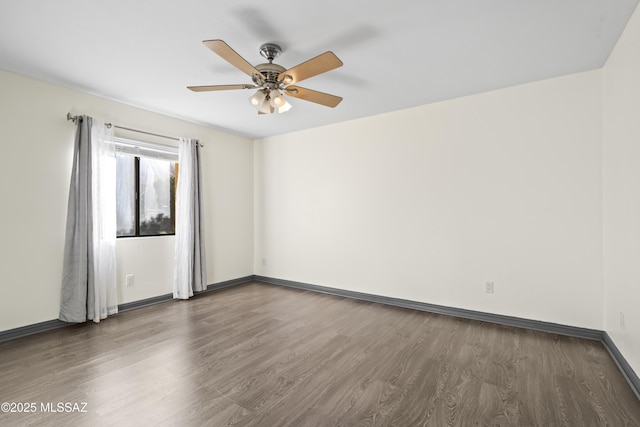 unfurnished room featuring ceiling fan and dark hardwood / wood-style flooring