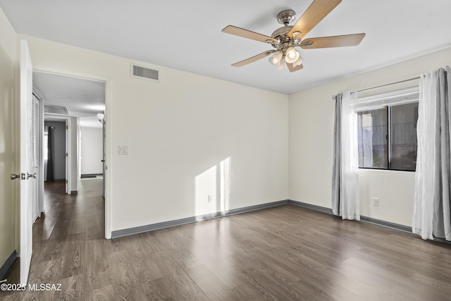 spare room with ceiling fan and dark hardwood / wood-style flooring