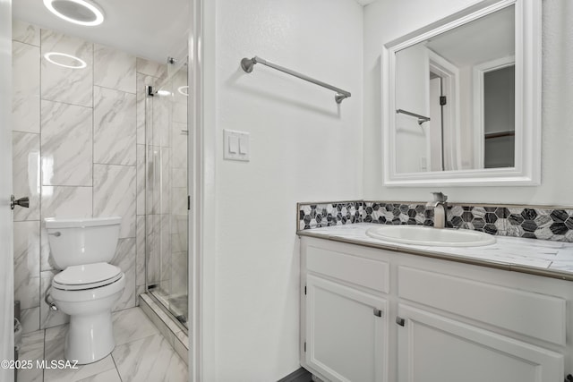 bathroom with toilet, a shower with door, and vanity