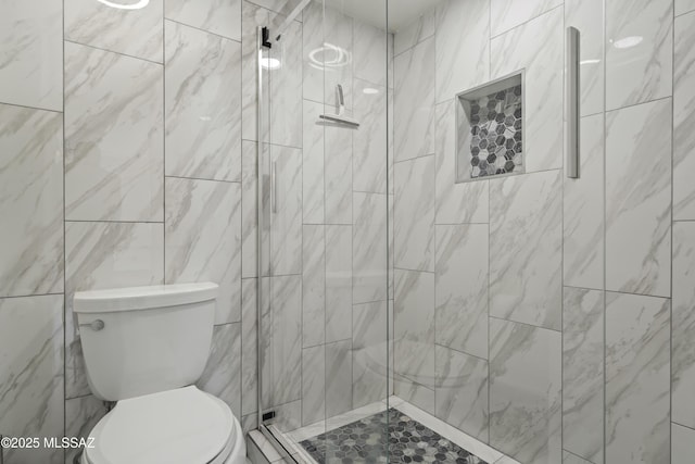 bathroom featuring toilet and an enclosed shower