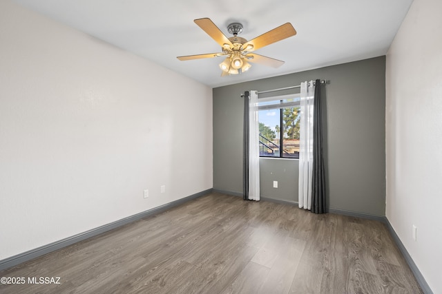 unfurnished room with ceiling fan and hardwood / wood-style floors