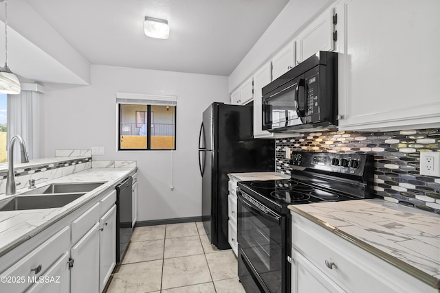 kitchen featuring black appliances, white cabinetry, sink, decorative light fixtures, and light tile patterned flooring