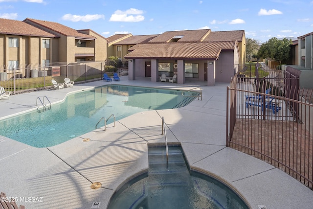 view of pool with a patio and a community hot tub