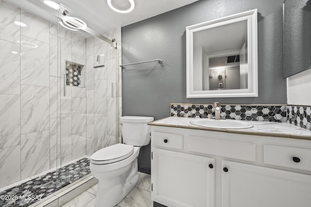 bathroom with a shower with door, toilet, and vanity