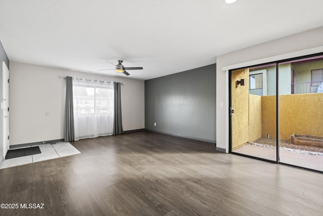 spare room with ceiling fan and hardwood / wood-style flooring