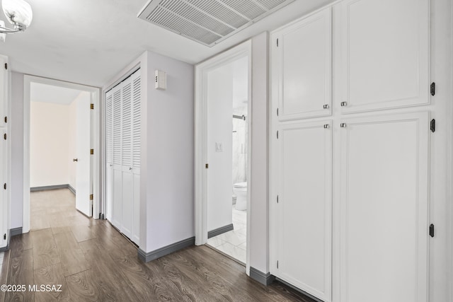 corridor featuring dark wood-type flooring