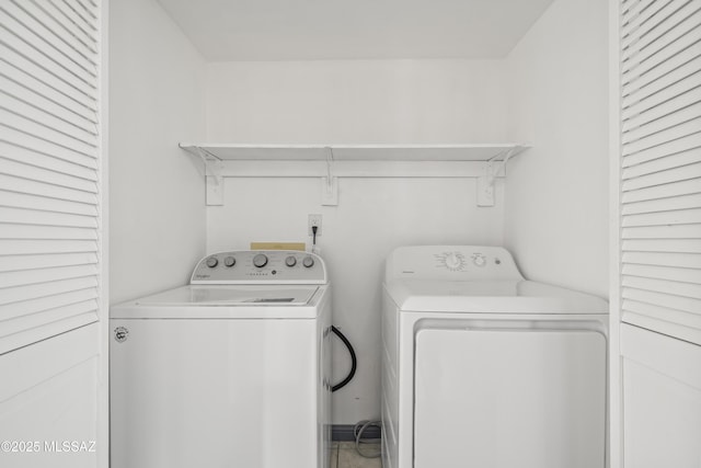 clothes washing area with washing machine and dryer