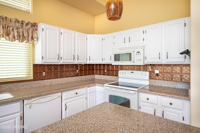 kitchen with decorative backsplash, a sink, white cabinets, and white appliances