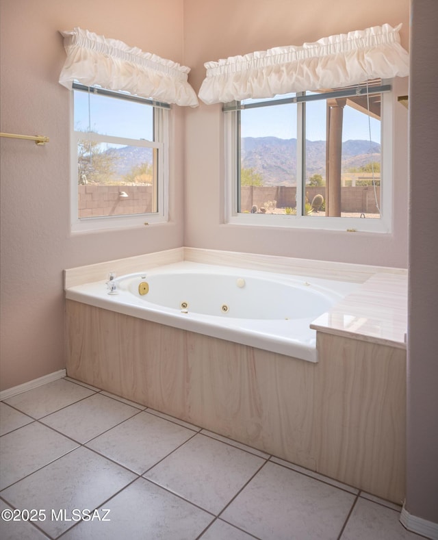full bathroom featuring tile patterned flooring, a mountain view, and a tub with jets