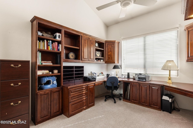 office area with lofted ceiling, built in desk, light carpet, and ceiling fan