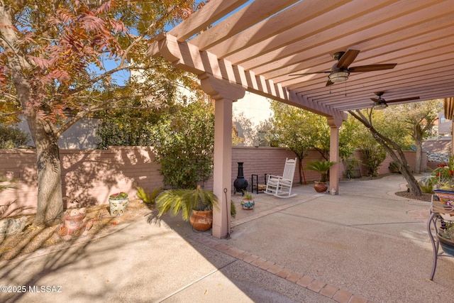 view of patio / terrace with ceiling fan and a pergola