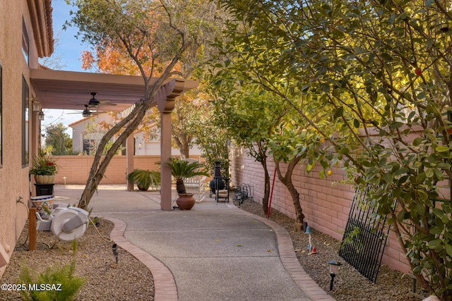 view of patio featuring ceiling fan and a pergola