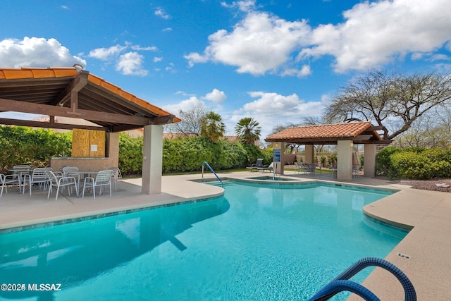 view of swimming pool with a gazebo and a patio area