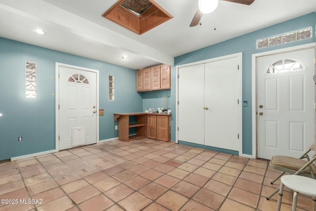 kitchen with kitchen peninsula, stainless steel appliances, and light brown cabinetry