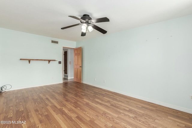 empty room featuring ceiling fan and light hardwood / wood-style floors