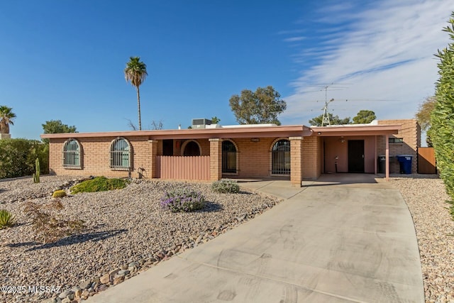 ranch-style home featuring a carport