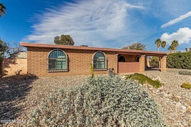 single story home with a carport