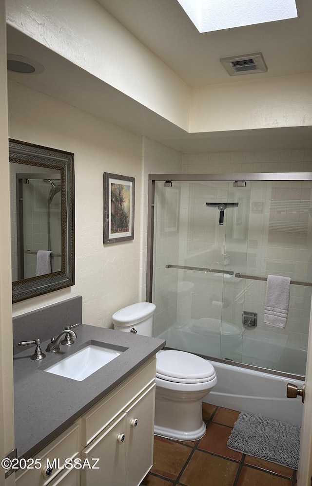 full bathroom with tile patterned flooring, vanity, toilet, and enclosed tub / shower combo