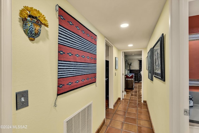 hall featuring dark tile patterned floors