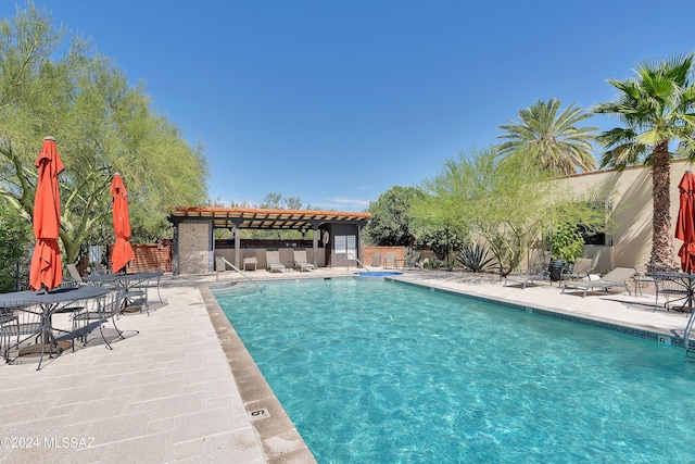 view of pool with a pergola and a patio