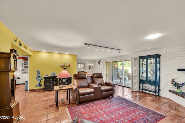 living room featuring a chandelier, rail lighting, and tile patterned floors