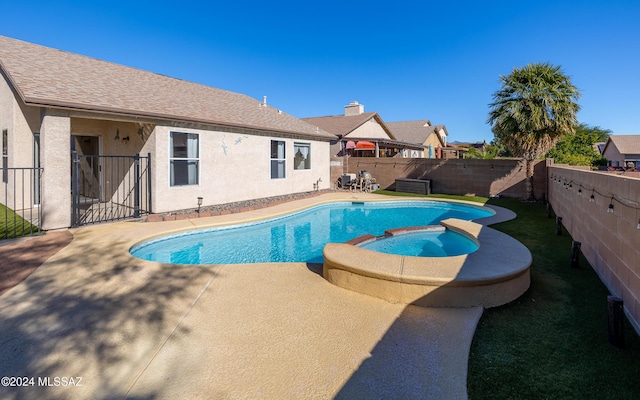 view of pool featuring a patio area and an in ground hot tub