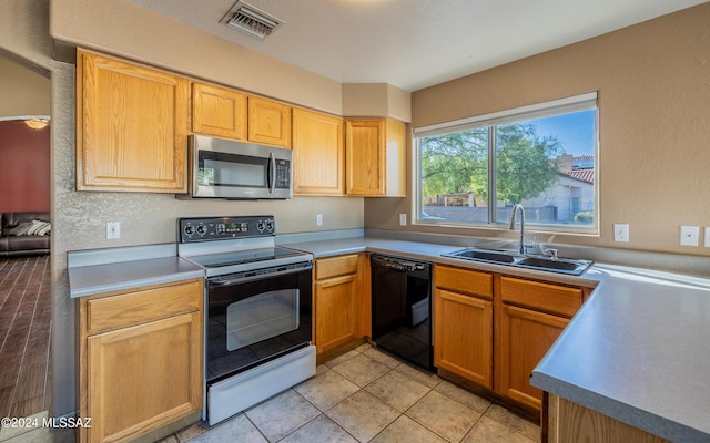 kitchen featuring electric stove, sink, light tile patterned floors, and black dishwasher