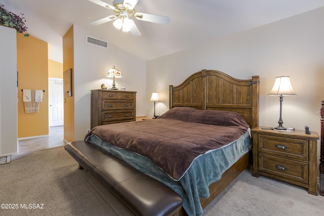 bedroom featuring visible vents, light carpet, lofted ceiling, and a ceiling fan