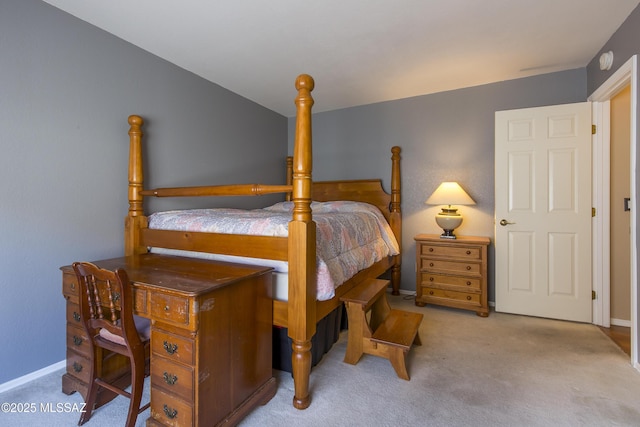 bedroom featuring carpet and baseboards