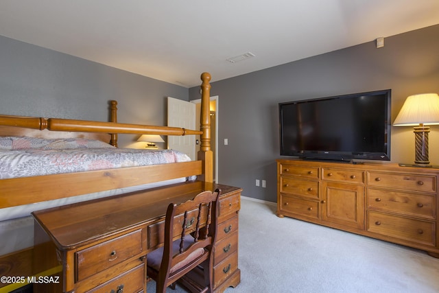 bedroom with visible vents, light carpet, and baseboards