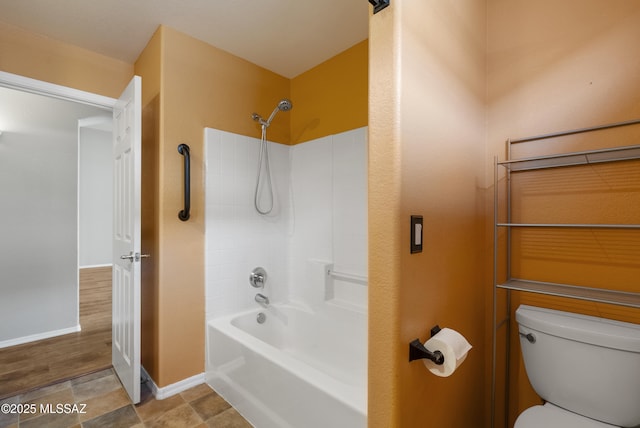 10187 E Watson Dr, Tucson, AZ 85730 - bathroom featuring toilet, baseboards, and washtub / shower combination