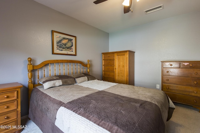 carpeted bedroom featuring visible vents, a ceiling fan, and vaulted ceiling