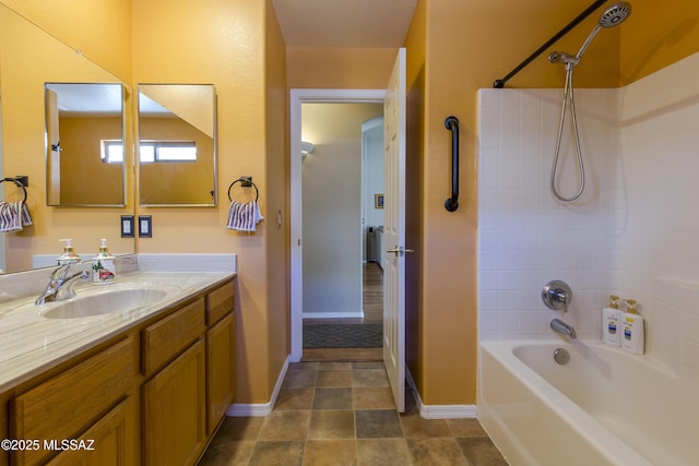 full bath featuring baseboards, vanity, and shower / bathtub combination