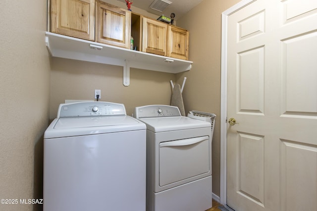 10187 E Watson Dr, Tucson, AZ 85730 - clothes washing area featuring washer and dryer and cabinet space