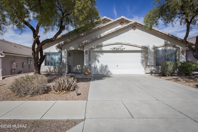 10187 E Watson Dr, Tucson, AZ 85730 - view of front of home featuring an attached garage, driveway, stucco siding, and a tile roof