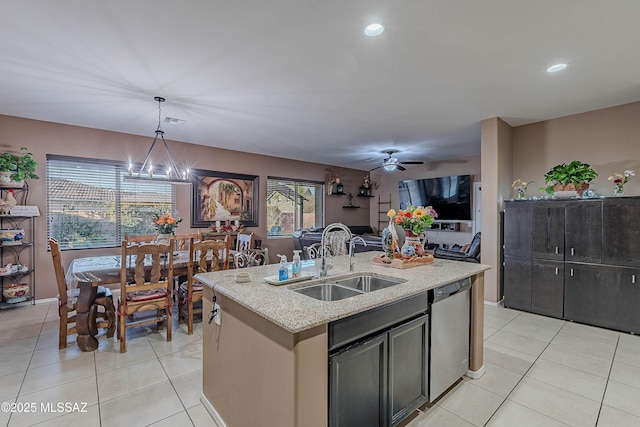 kitchen with sink, hanging light fixtures, stainless steel dishwasher, a kitchen island with sink, and ceiling fan with notable chandelier