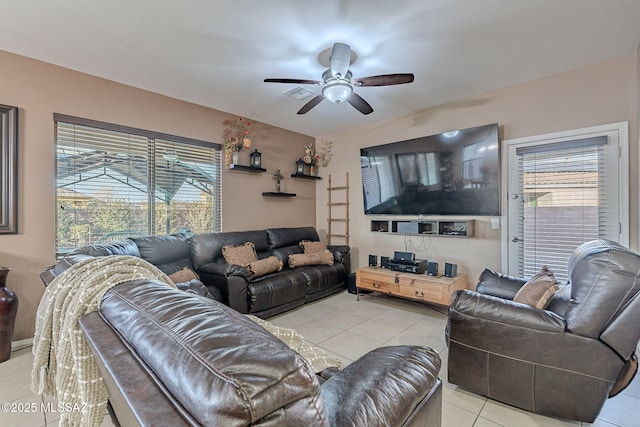 living room featuring ceiling fan, light tile patterned flooring, and a healthy amount of sunlight