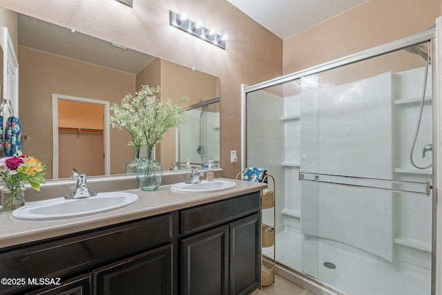 bathroom with vanity and a shower with door