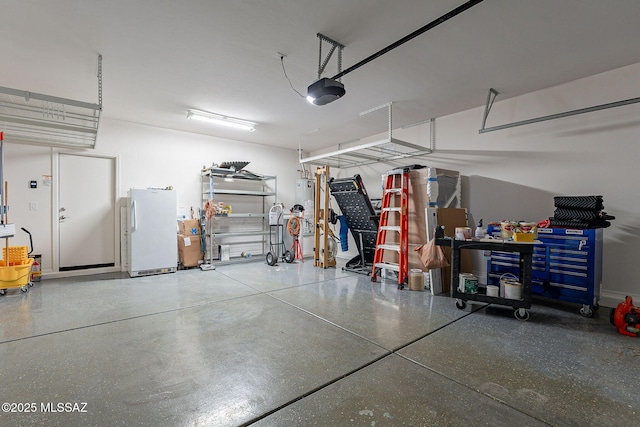 garage featuring a garage door opener and white refrigerator