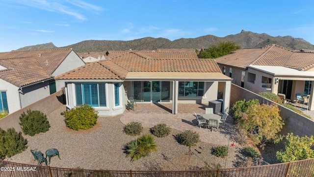 back of house featuring a patio area and a mountain view